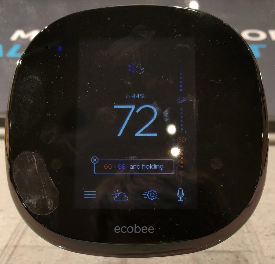 An ecobee4 smart thermostat, a black square unit with a colour display.