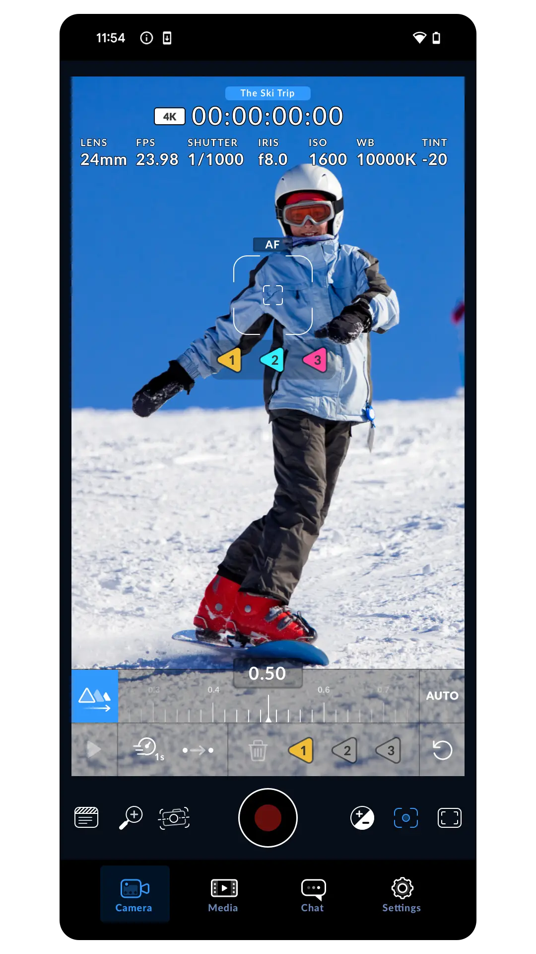 Camera viewfinder tracking a snowboarder with an AF box, colored focus markers and a 0.50 focus slider set to Auto