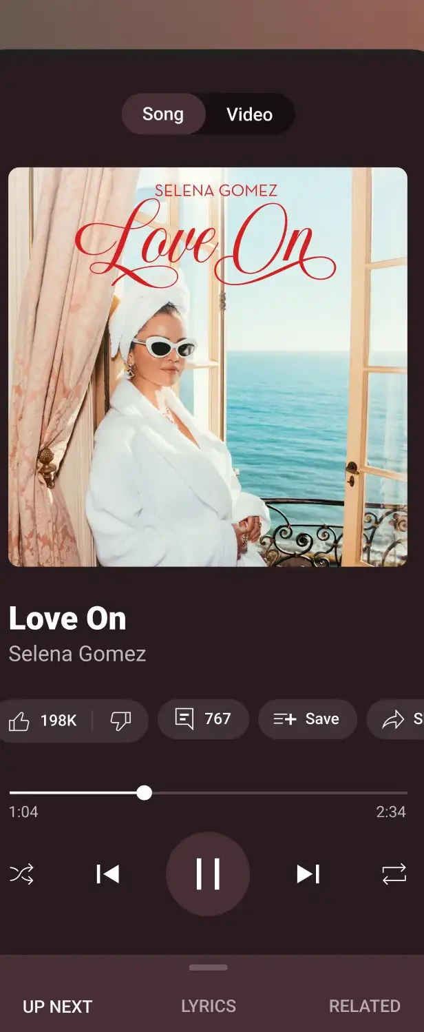 The YouTube Music now playing screen with Song and Video tabs at the top and Up next, Lyrics and Related tabs at the bottom