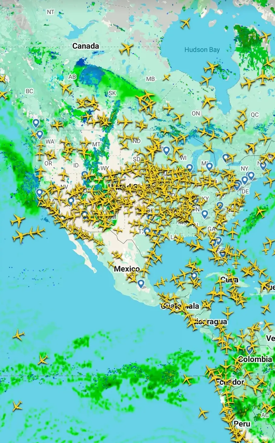 The Flightradar24 map spans North, Central and South America with hundreds of yellow aircraft icons over a green and blue precipitation overlay, labelled with Canada, Hudson Bay, Mexico, Cuba, Colombia, Ecuador and Peru.