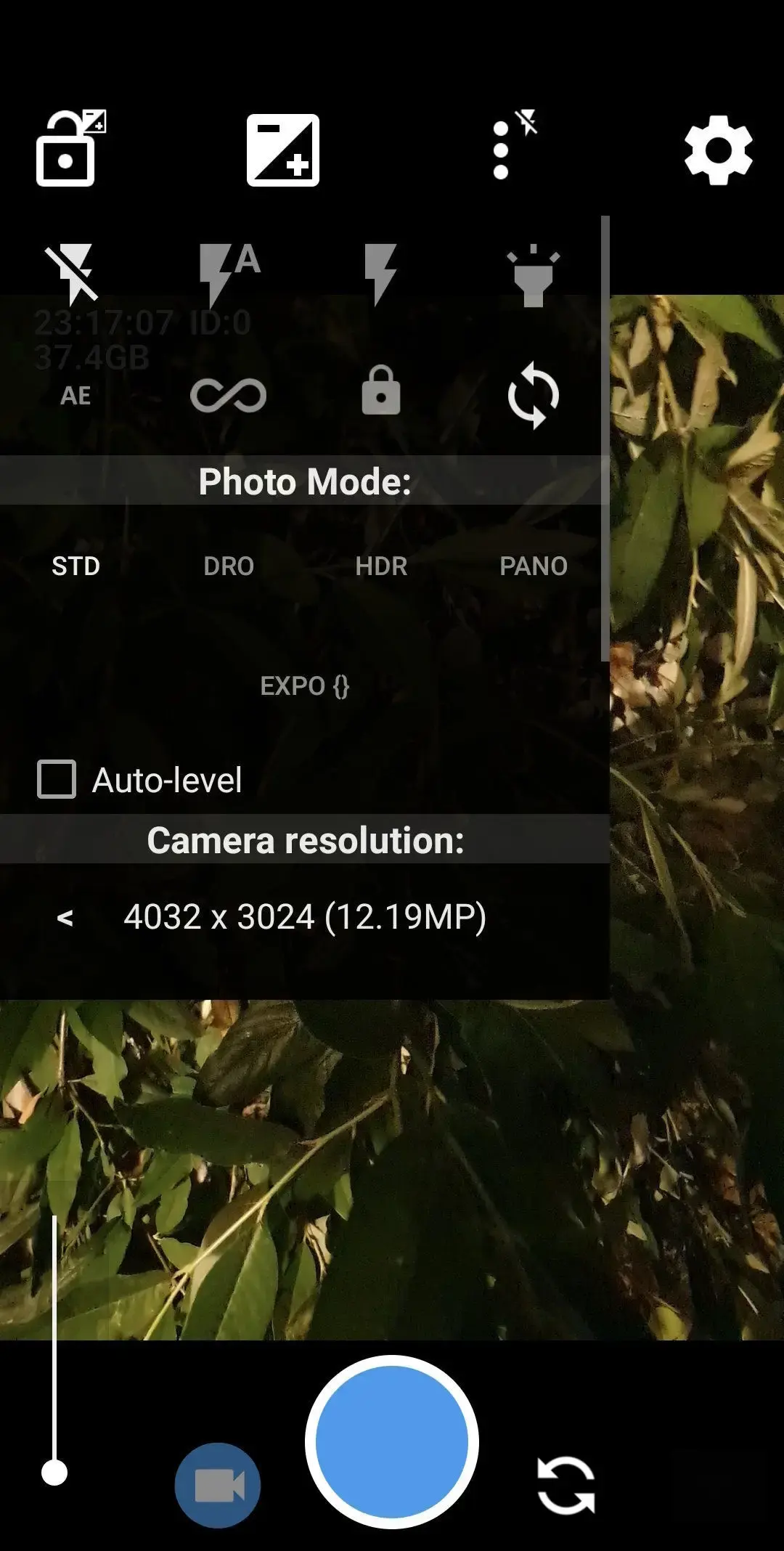 Open Camera's settings popup open over the viewfinder, listing exposure-compensation and exposure-lock icons, four flash modes, an AE / infinity-focus / lock row, Photo Mode options STD, DRO, HDR and PANO, exposure bracketing, an Auto-level checkbox and a camera resolution of 4032 x 3024 (12.19MP).